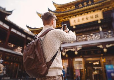 Imagem ilustrativa sobre visto chinês para brasileiros mostrando um jovem brasileiro fotografando pontos turísticos chineses após conseguir seu visto de turismo com o auxílio da Singular Mobilidade Internacional.